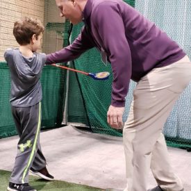Evan Scobie teaching boy