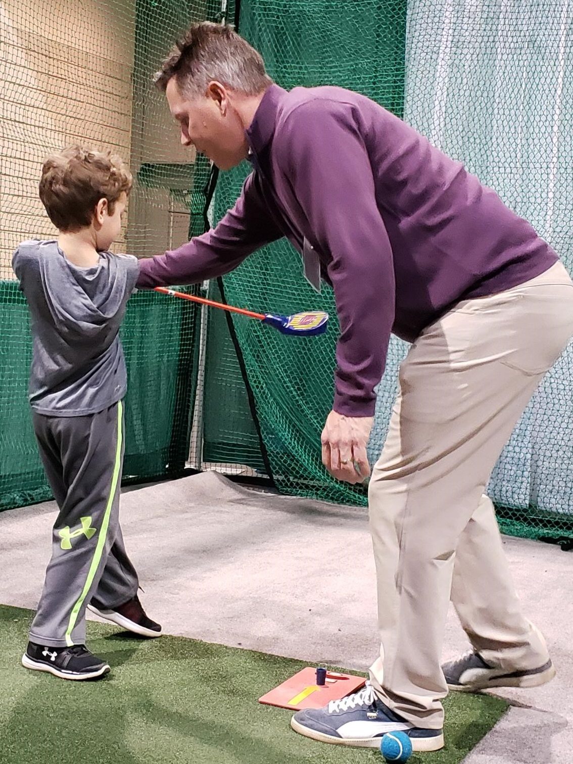 Evan Scobie teaching boy