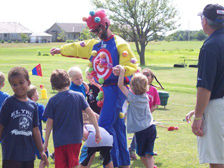 Kids playing with golf teacher