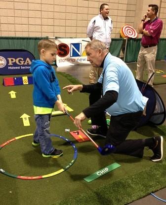 Golfer helping a kid
