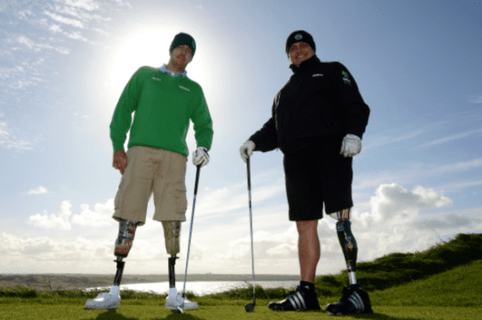 Two men standing with golf clubs